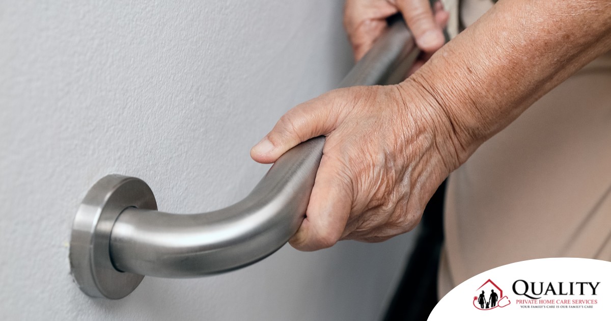An older adult uses a grab bar representing one of the home modifications that is helpful for fall prevention for elderly adults.